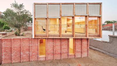 Casa sobre un zócalo de ladrillo, de Ágora Arquitectura.